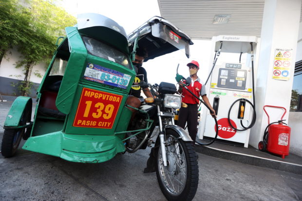 Tricycle at a gas station